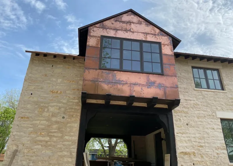 Copper metal panel facade on a stone building for Metal Roof Coating in Boulder Hill