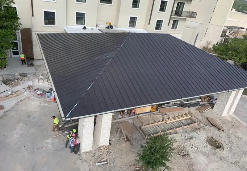 Metal roofing installation team working on a commercial building in Boulder Hill